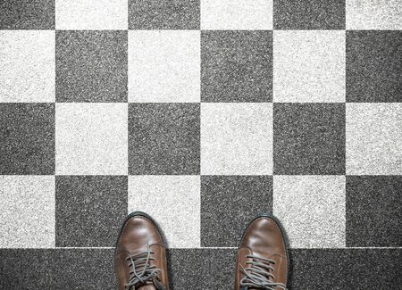 businessman stand on chess tile floorの写真素材