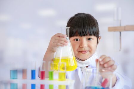 Asian girl doing laboratory test, science classroom