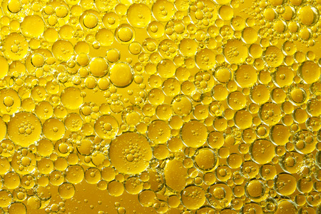 golden yellow bubble oil, abstract backgroundの写真素材