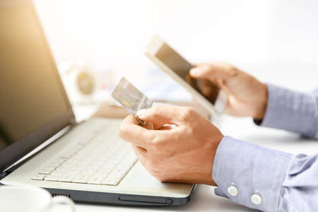 businessman do online shopping with credit card and mobile phoneの写真素材