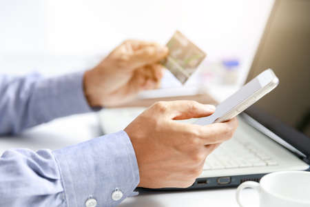 businessman do online shopping with credit card and mobile phoneの写真素材