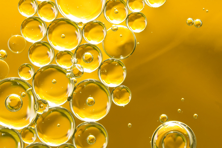 golden yellow bubble oil, abstract backgroundの写真素材