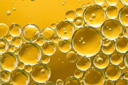 golden yellow bubble oil, abstract backgroundの写真素材