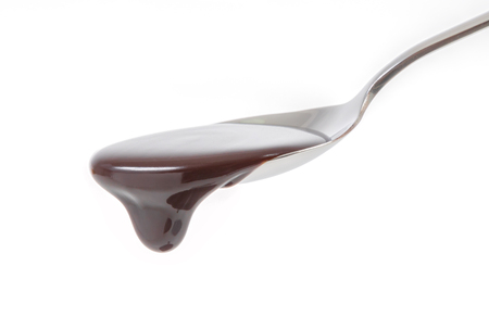 chocolate syrup pouring on spoon, cooking, bakingの写真素材