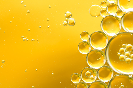 golden yellow bubble oil, abstract backgroundの写真素材