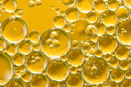 golden yellow bubble oil, abstract backgroundの写真素材