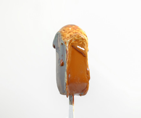 melting melted chocolate ice cream in summer hot weatherの写真素材