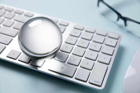 computer keyboard with eyeglasses and crystal ballの写真素材