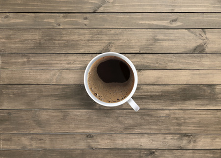 Hot americano black coffee in white mug on wooden tableの写真素材