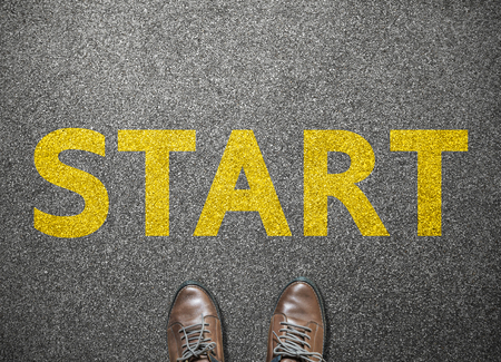 Businessman shoes step to word start on road, business conceptの写真素材