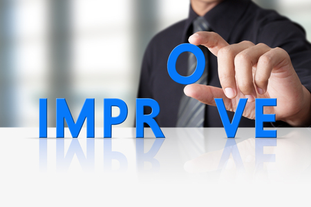 Businessman hand and word text improve, successful conceptの写真素材