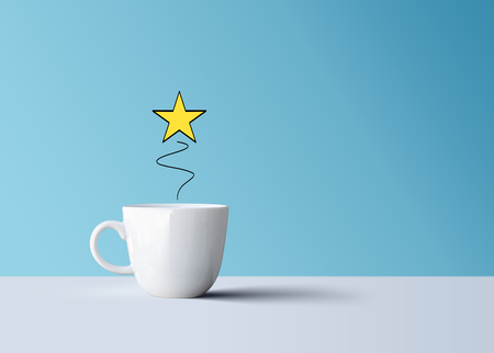 Bright shiny star and white coffee mug, creative ideaの写真素材
