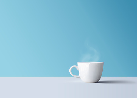 Isolated hot black coffee in white coffee mug with smokeの写真素材