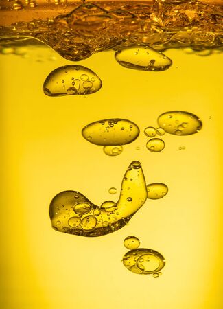 Golden yellow bubble oil droplet, abstractの写真素材