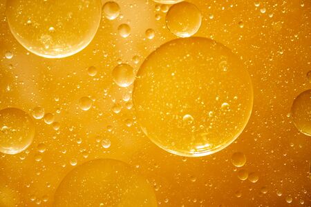 golden yellow bubble oil droplet, abstract backgroundの写真素材