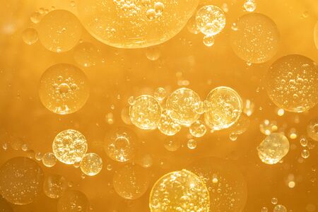Golden yellow bubble oil droplet, abstractの写真素材