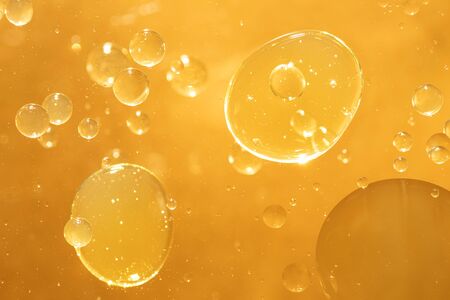 golden yellow bubble oil droplet, abstract backgroundの写真素材