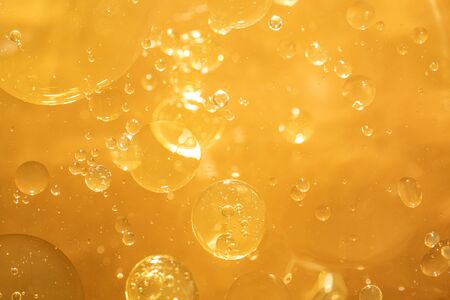 golden yellow bubble oil droplet, abstract backgroundの写真素材