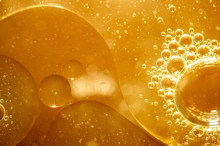 Golden yellow bubble oil or serum, Abstract Yellow water bubbles backgroundの写真素材
