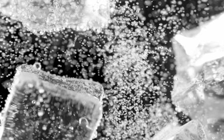 ice cube in fizzy splashing water with soda bubbleの写真素材