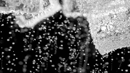 ice cube in fizzy splashing water with soda bubbleの写真素材