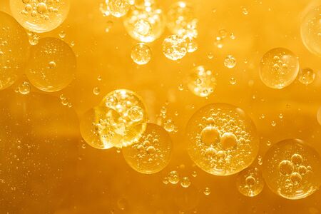 golden yellow bubble oil droplet, abstract backgroundの写真素材