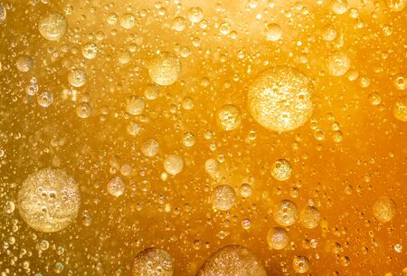 golden yellow bubble oil droplet, abstract backgroundの写真素材