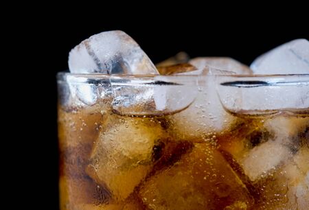 Ice cube in fizzy splashing water with soda bubbleの写真素材