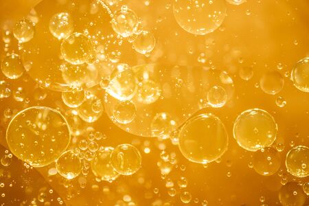 golden yellow bubble oil droplet, abstract backgroundの写真素材