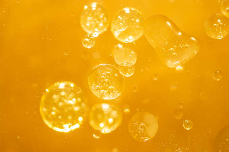golden yellow bubble oil droplet, abstract backgroundの写真素材