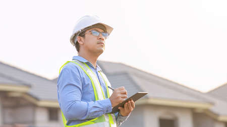 engineer working on digital tablet at construction siteの写真素材