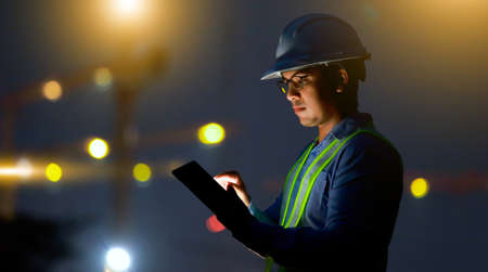 engineer working on digital tablet at construction siteの写真素材