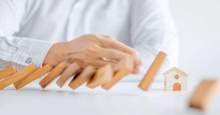 home protection with insurance concept with wooden home model and wooden blocksの写真素材