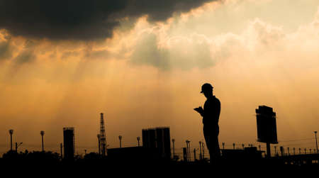 engineer working on digital tablet at construction siteの写真素材