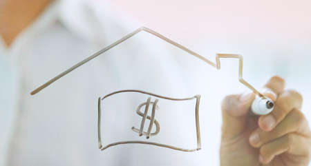 businessman drawing money dollar icon and house icon, saving and insuranceの写真素材