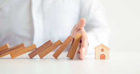 home protection with insurance concept with wooden home model and wooden blocksの写真素材