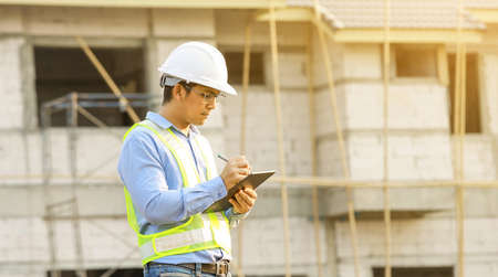 engineer working on digital tablet at construction siteの写真素材