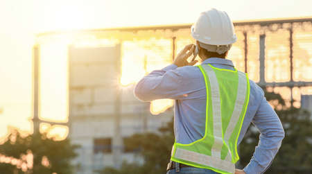 Engineer talk on mobile phone at construction siteの写真素材