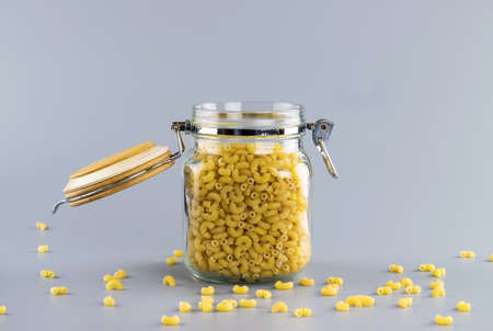 uncooked dry pasta in glass jarの写真素材