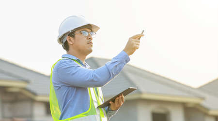 engineer working on digital tablet at construction siteの写真素材
