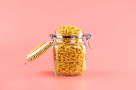 uncooked dry pasta in glass jarの写真素材