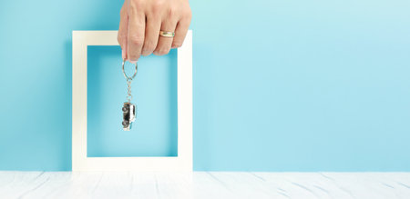 businessman hand holding a car key chain, insurance conceptの写真素材