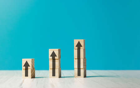 wooden cubes with rising business growth graph chartの写真素材