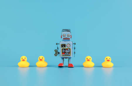 vintage retro robot and Yellow Rubber Bath Ducks, leadership concept