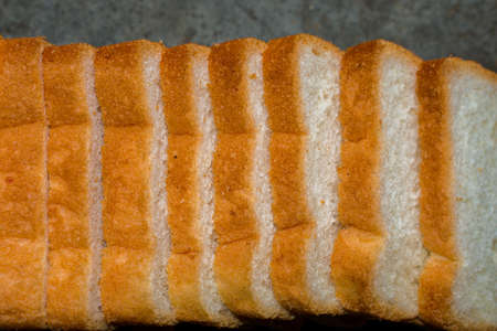 A loaf of bread is placed on the table which are going to be eaten with selected focus.