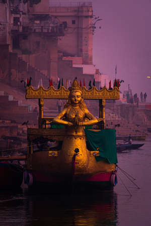 A beautiful indian boat of golden colors taken in the morning time in Varanasi with selective focus.の写真素材