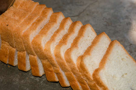 A loaf of bread is placed on the table which are going to be eaten with selected focus.