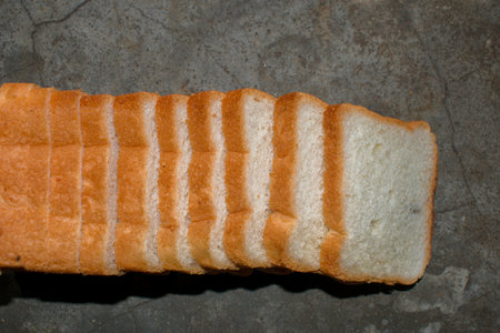 A loaf of bread is placed on the table which are going to be eaten with selected focus.
