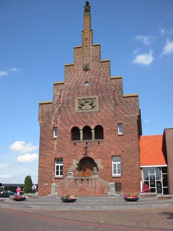 an typical dutch church with blue skyの写真素材