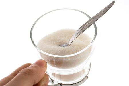 a cup of sugar and tea spoon の写真素材